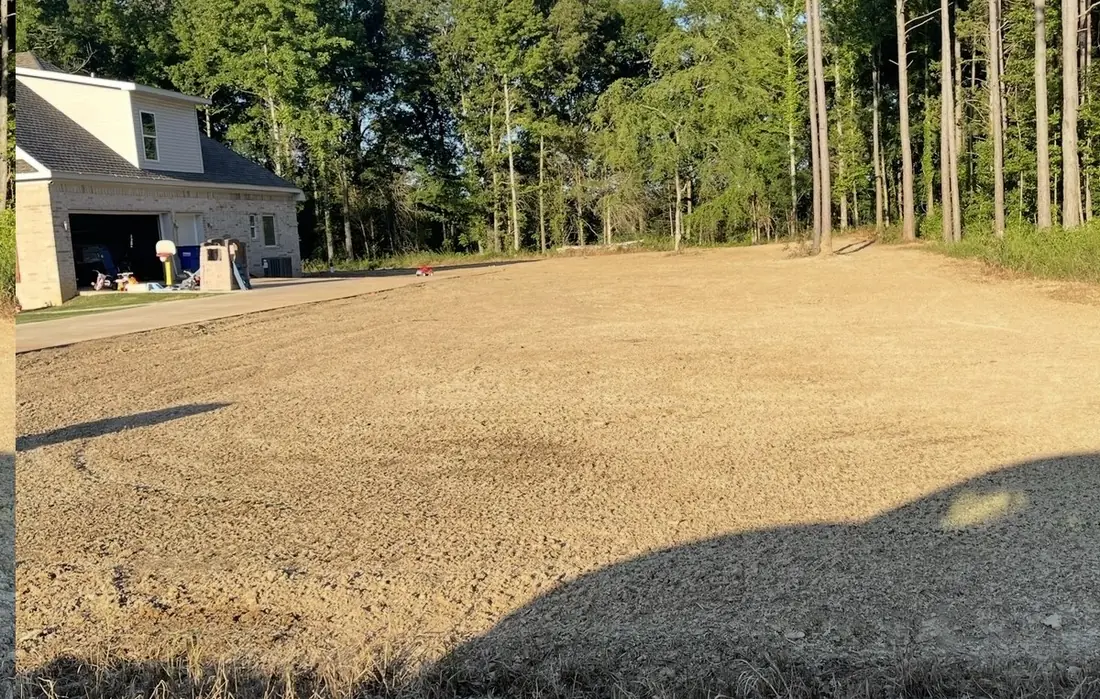 The same yard as bare graded dirt on June 19, before hydroseeding